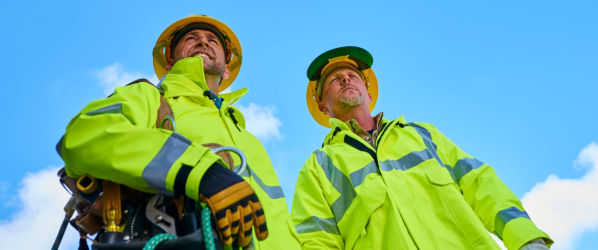 Two utility workers wearing Lakeland Arc X rainwear.