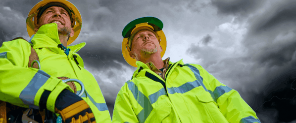 Workers wearing Lakeland FR-ARC Rainwear while working in a storm